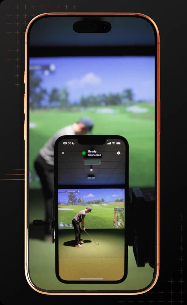 A smartphone showing a golf simulation, with a golfer on the screen preparing to swing, mirrored against a blurred real-life backdrop.
